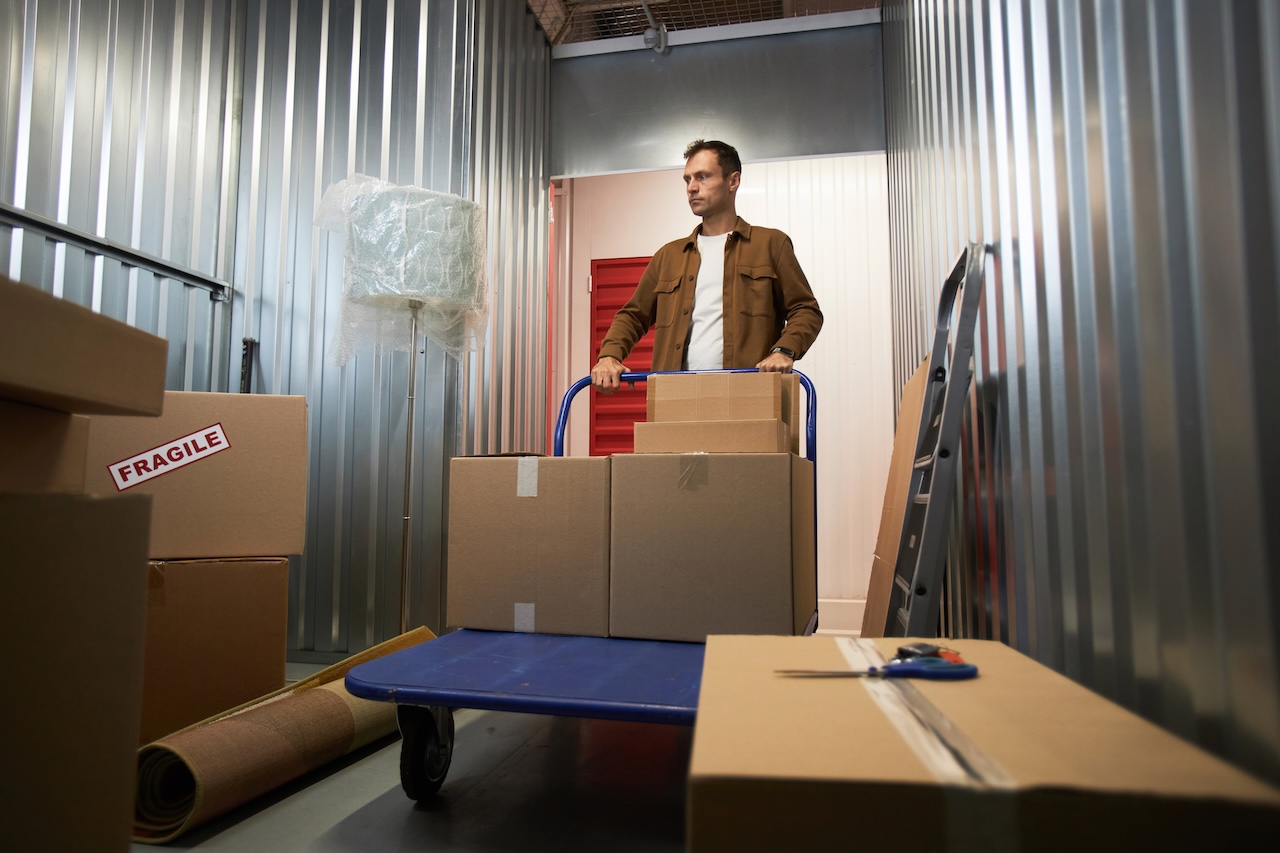 man putting items in climate controlled storage unit